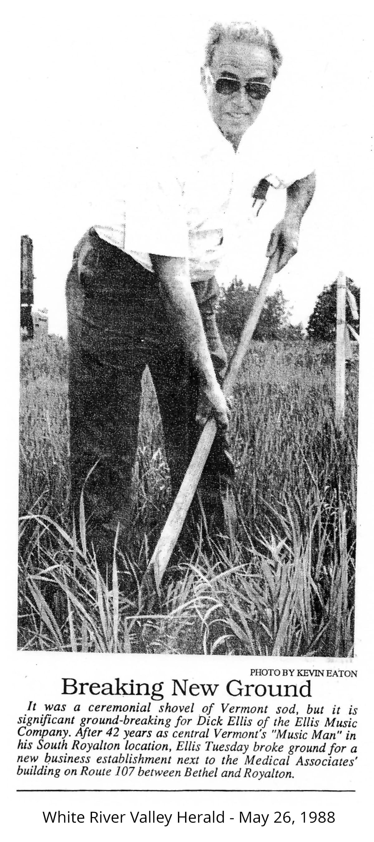Photo of Dick Ellis with a shovel digging at the site of the new Ellis Music building location
