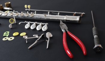 Picture of disassembled flute with repair tools