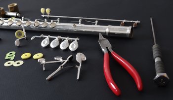 Picture of disassembled flute with repair tools